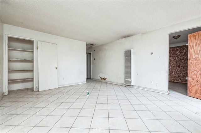 interior space with a textured ceiling and multiple closets