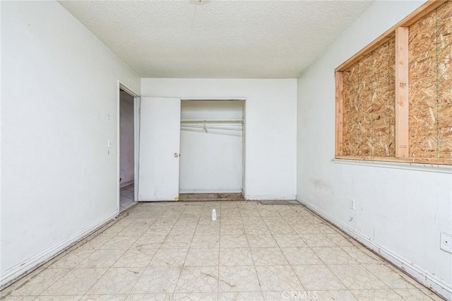 unfurnished bedroom with a closet and a textured ceiling