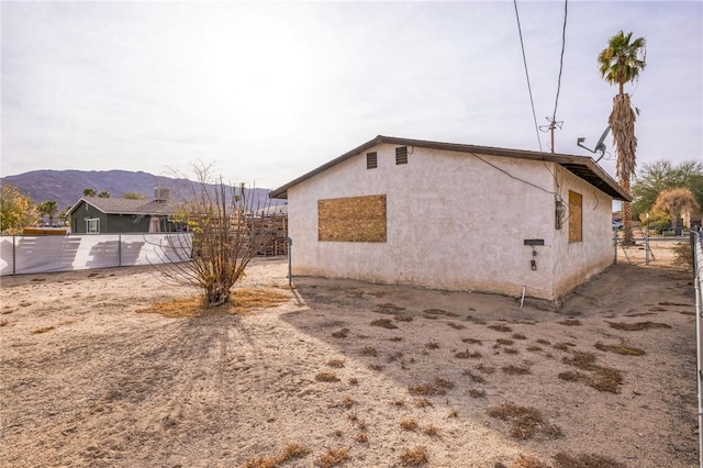 view of property exterior with a mountain view