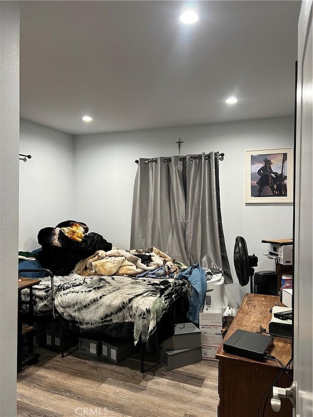 bedroom with hardwood / wood-style floors