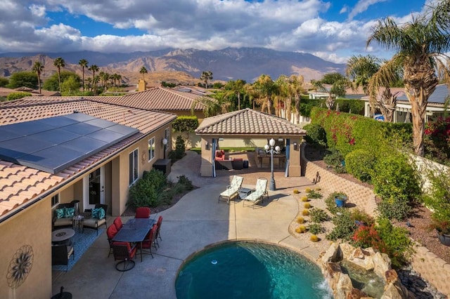 exterior space with an outdoor living space, a gazebo, a patio area, and a mountain view