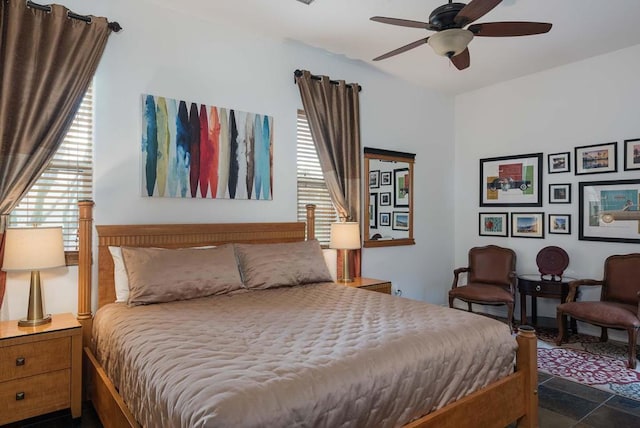 bedroom featuring ceiling fan and multiple windows