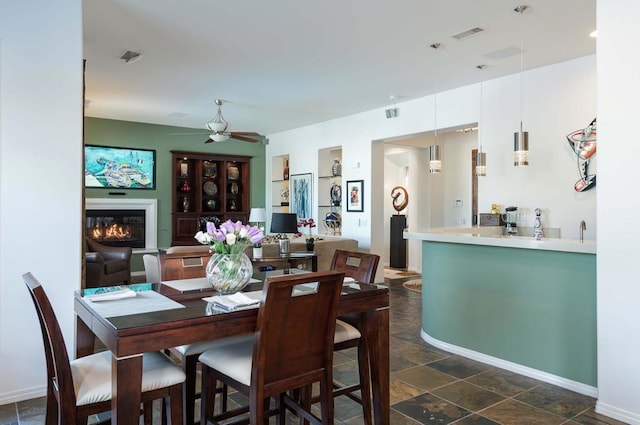 dining space featuring ceiling fan