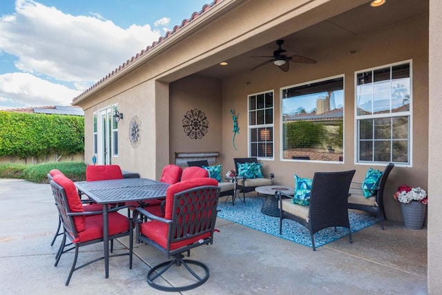 view of patio / terrace with an outdoor living space and ceiling fan