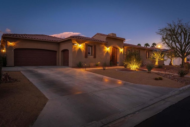 mediterranean / spanish-style home featuring a garage