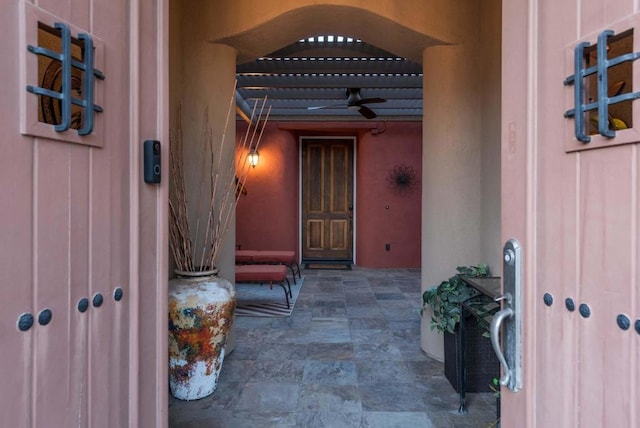 view of exterior entry with ceiling fan