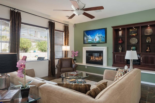 living room with ceiling fan and plenty of natural light