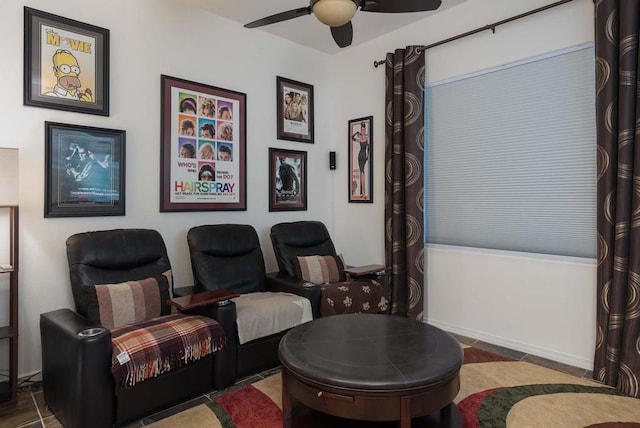 cinema with ceiling fan and dark tile patterned floors