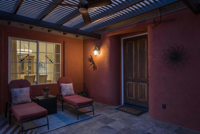 property entrance featuring ceiling fan, a pergola, and a patio