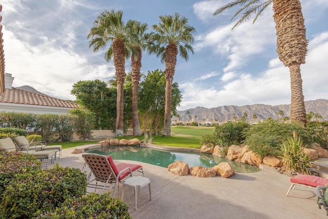 view of pool featuring a mountain view and a patio