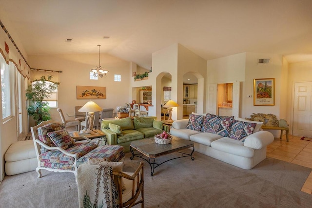 tiled living room featuring lofted ceiling and a chandelier