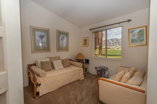 carpeted living room with a mountain view and lofted ceiling