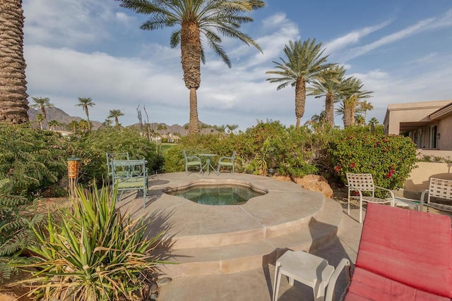 view of swimming pool with a mountain view and a patio