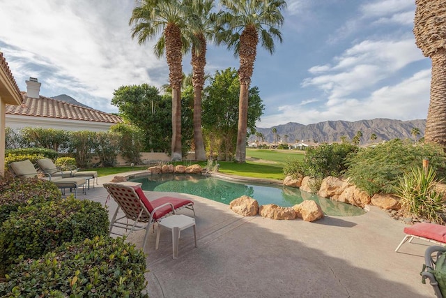 view of pool with a mountain view and a patio