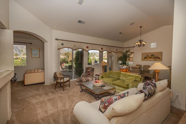 carpeted living room featuring lofted ceiling and a chandelier