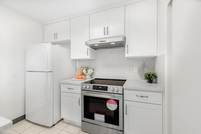 kitchen featuring stainless steel range with electric stovetop, light tile patterned floors, white cabinetry, and white refrigerator