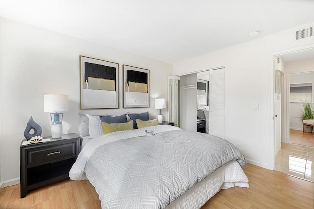 bedroom featuring light hardwood / wood-style floors and a closet