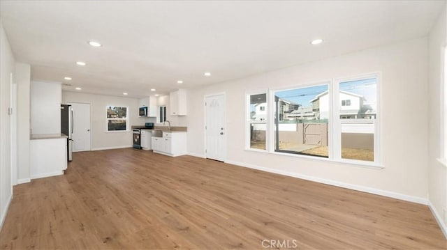 unfurnished living room featuring light hardwood / wood-style floors