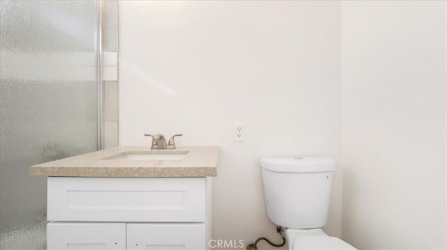 bathroom with toilet and vanity