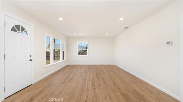 empty room with light hardwood / wood-style floors