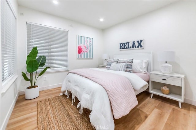 bedroom with hardwood / wood-style flooring