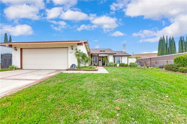 ranch-style home featuring a garage and a front lawn