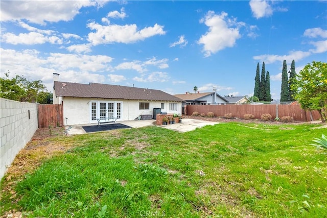 back of property with a patio, a yard, central air condition unit, and french doors