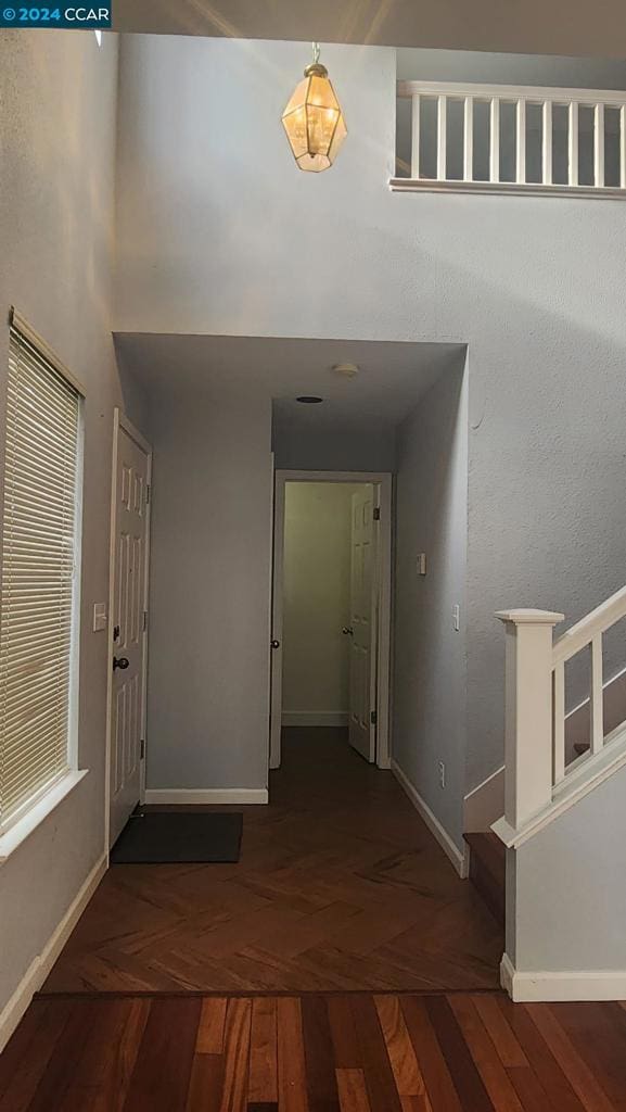 hallway featuring dark parquet flooring