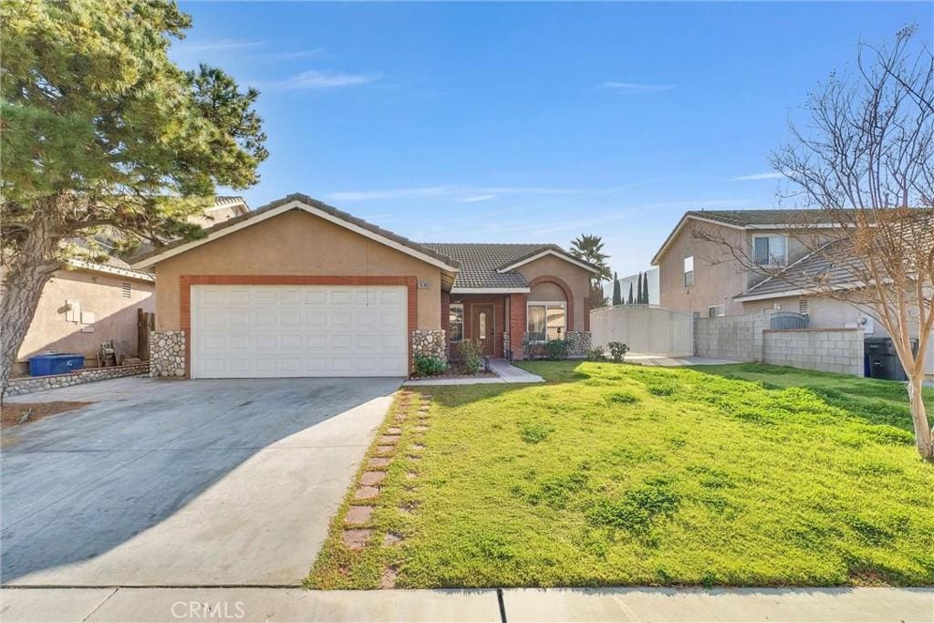 view of front of house with a front yard and a garage