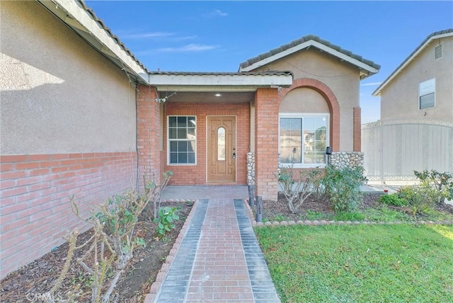 doorway to property featuring a lawn