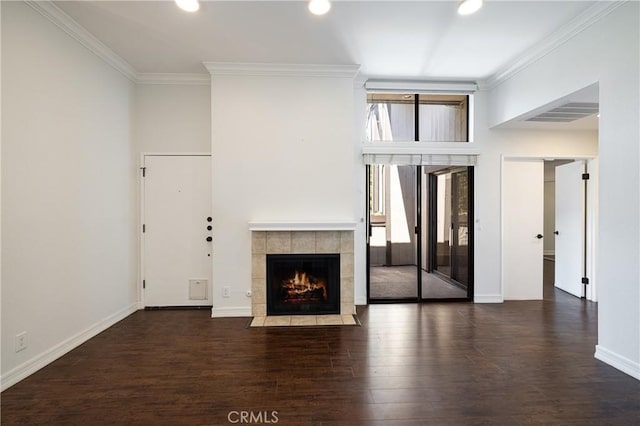 unfurnished living room featuring dark wood-type flooring, ornamental molding, and a fireplace