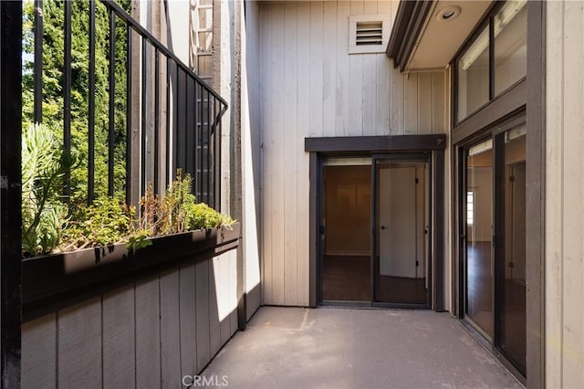 view of exterior entry featuring a balcony