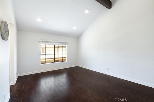 spare room featuring dark hardwood / wood-style floors and lofted ceiling with beams