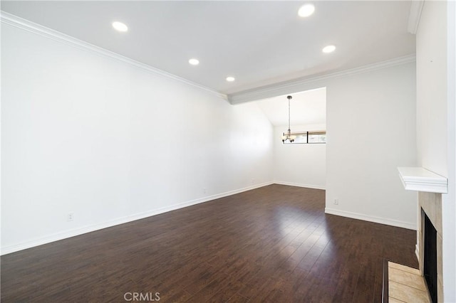 unfurnished living room with vaulted ceiling, dark hardwood / wood-style flooring, ornamental molding, and a notable chandelier