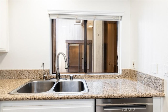 kitchen with white cabinetry, dishwasher, and sink