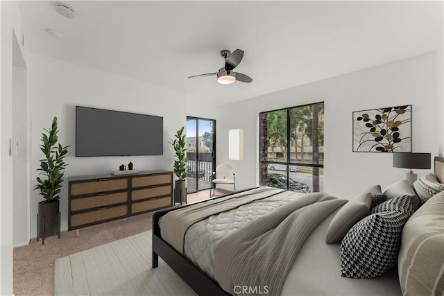 bedroom featuring ceiling fan, light colored carpet, and access to exterior