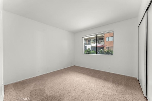 unfurnished bedroom with carpet floors and a closet