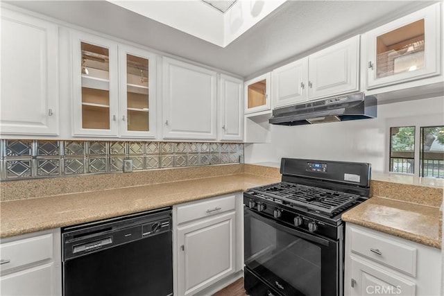 kitchen featuring backsplash, white cabinets, and black appliances