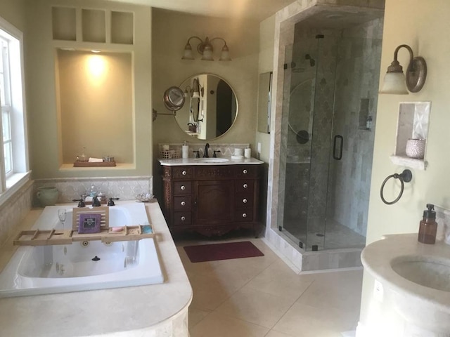 bathroom featuring vanity, independent shower and bath, tile patterned floors, and a wealth of natural light