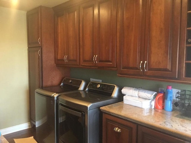 laundry room featuring cabinets and washer and clothes dryer