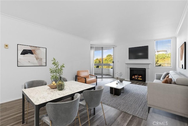 living room with dark wood-type flooring, a wealth of natural light, and ornamental molding