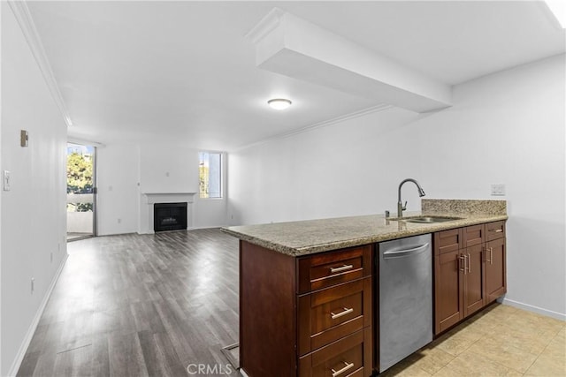 kitchen featuring sink, crown molding, light stone countertops, and dishwasher