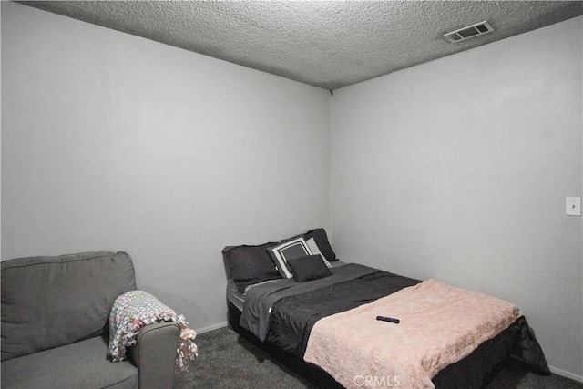 carpeted bedroom featuring a textured ceiling