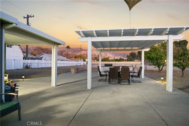 patio terrace at dusk with a pergola