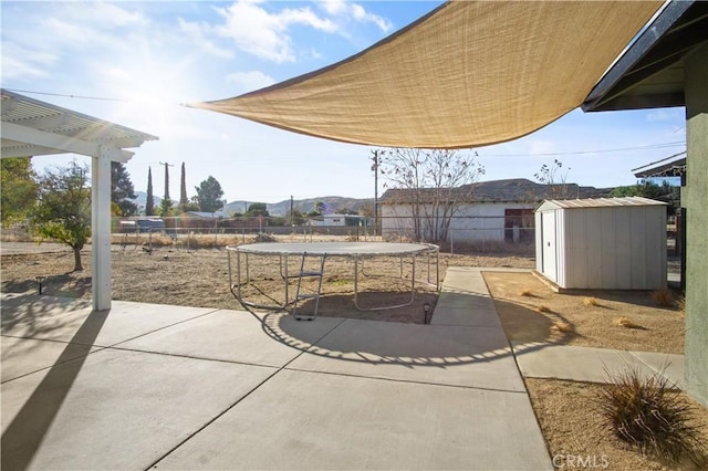 view of patio featuring a storage shed and a trampoline