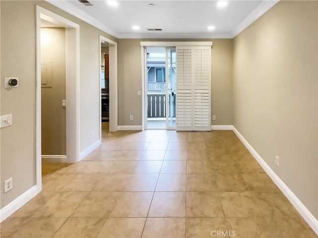 tiled spare room with crown molding