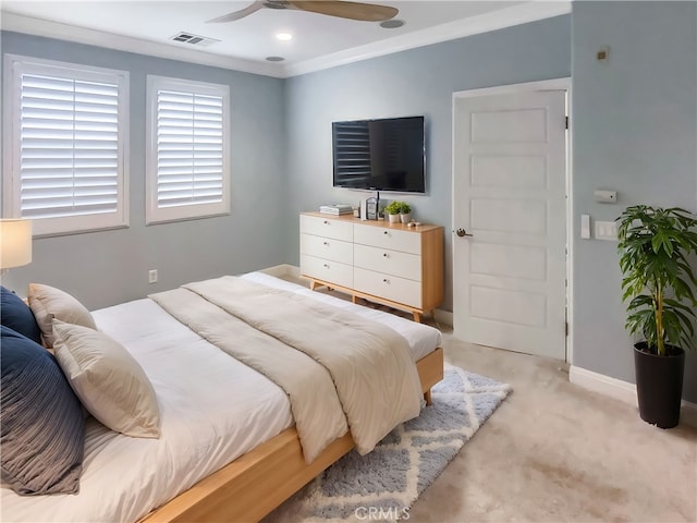 bedroom with visible vents, ceiling fan, baseboards, light colored carpet, and ornamental molding