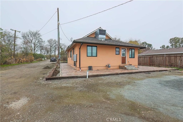 rear view of house featuring central air condition unit