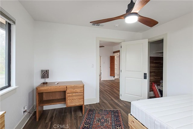 bedroom featuring ceiling fan, dark hardwood / wood-style flooring, and a closet