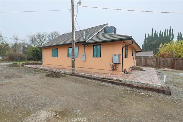 view of side of home with a patio area and central AC unit